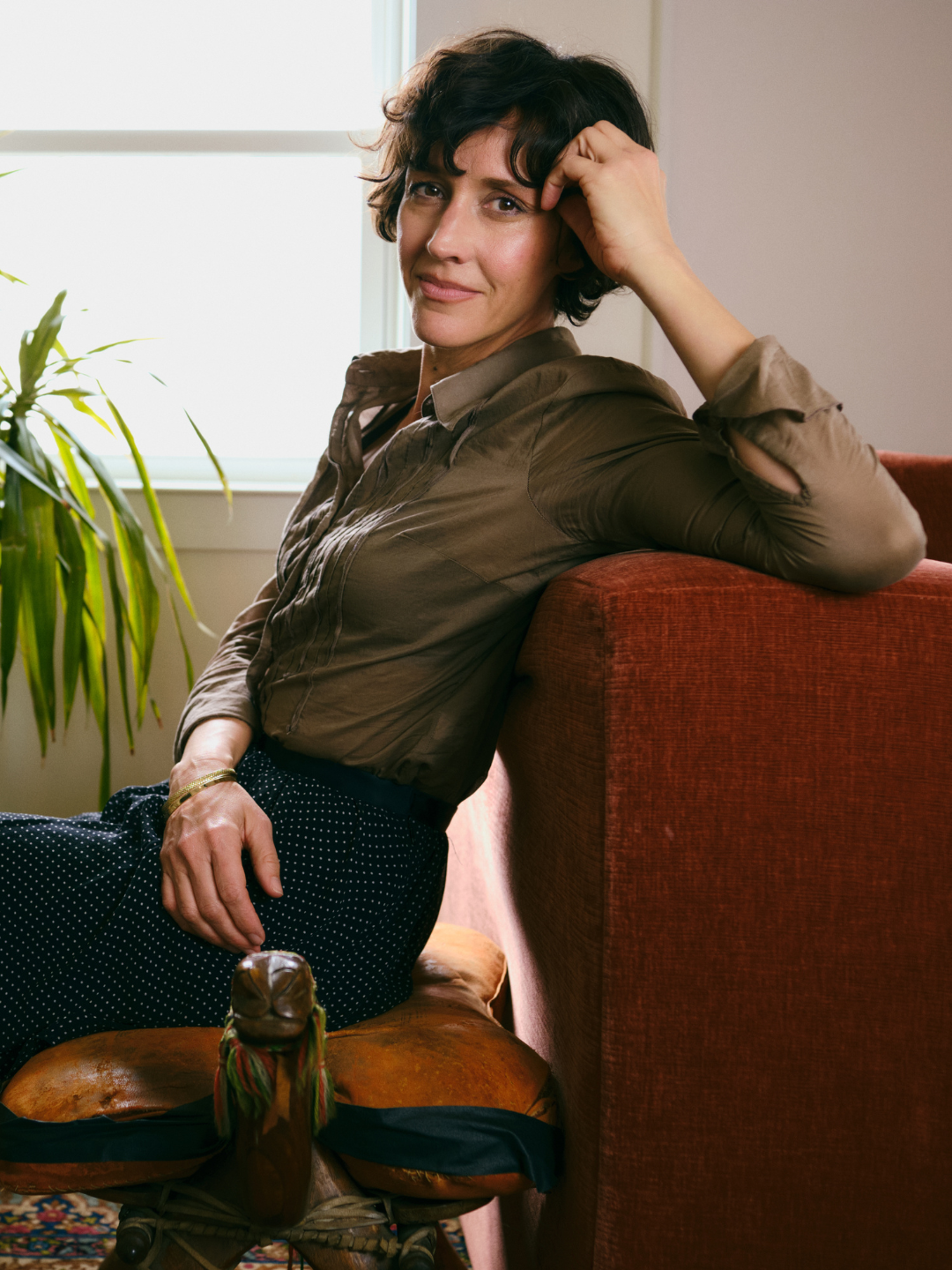 Christa Wells seated in a sunlit room, founder of Find Your Voice women’s retreat